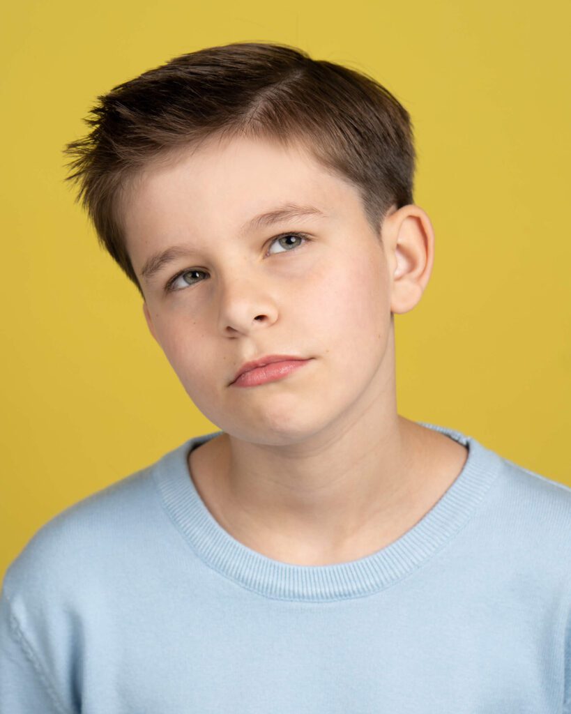 Boy in a Blue Shirt Over a Yellow Background