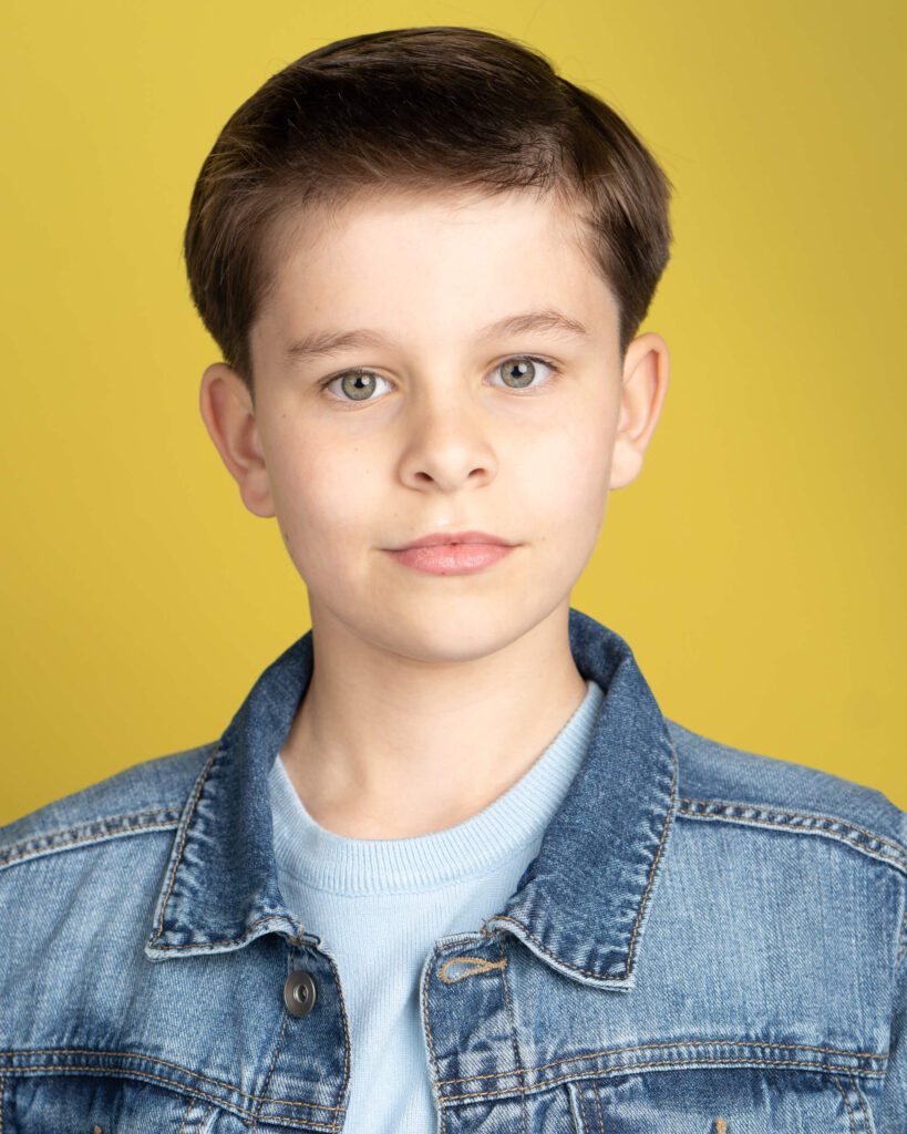 Boy in a Blue Denim Shirt Over a Yellow Background